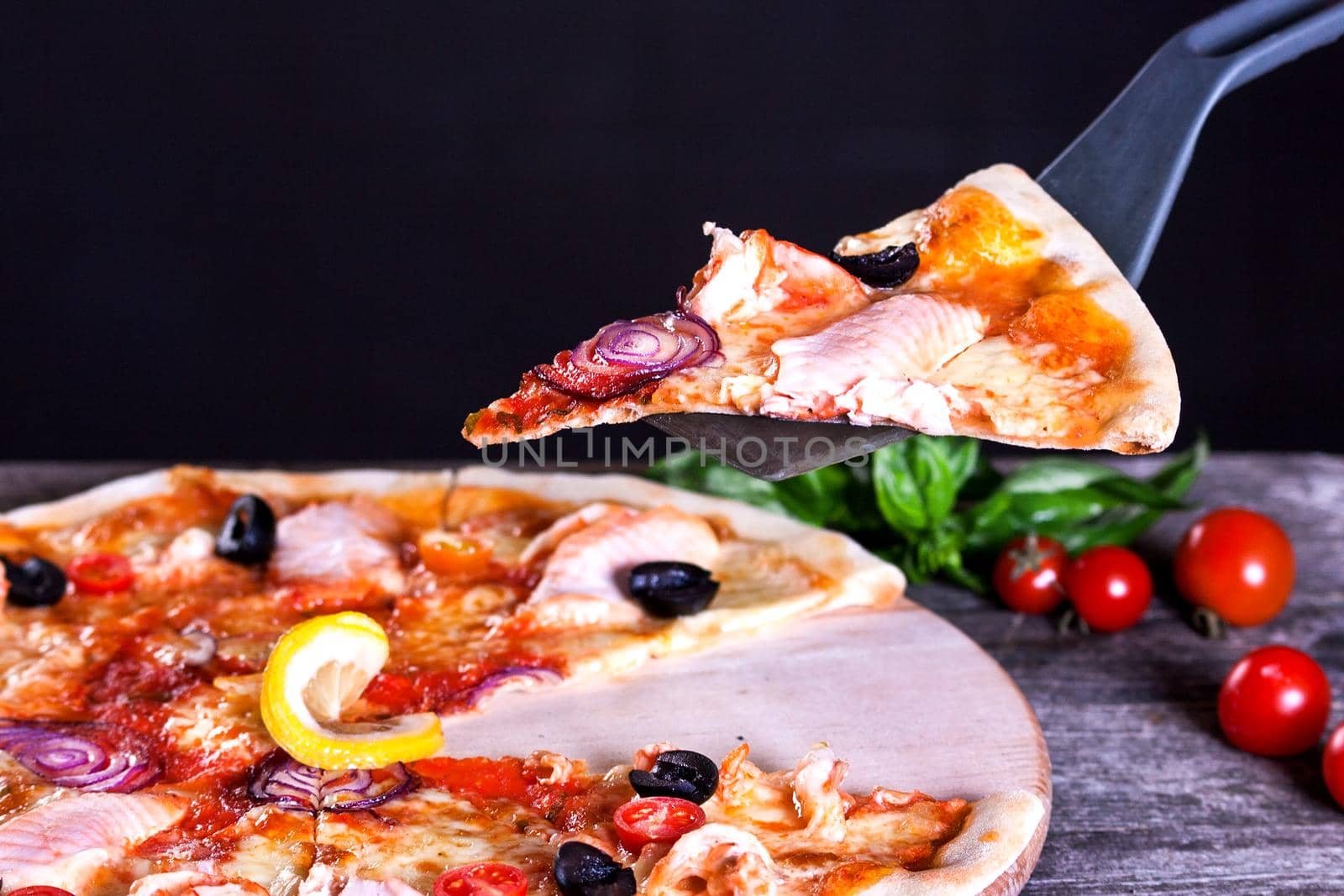 Delicious fresh Pizza with red fish and mozzarella on the wooden background. Top view.