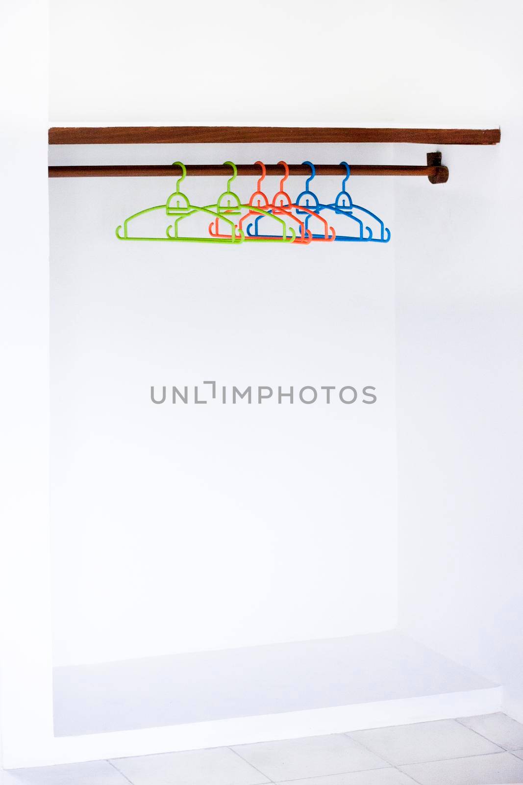 Nothing To Wear Design Sale Concept Wooden Coat Hanger on White Wall Copy Space. Empty wardrobe