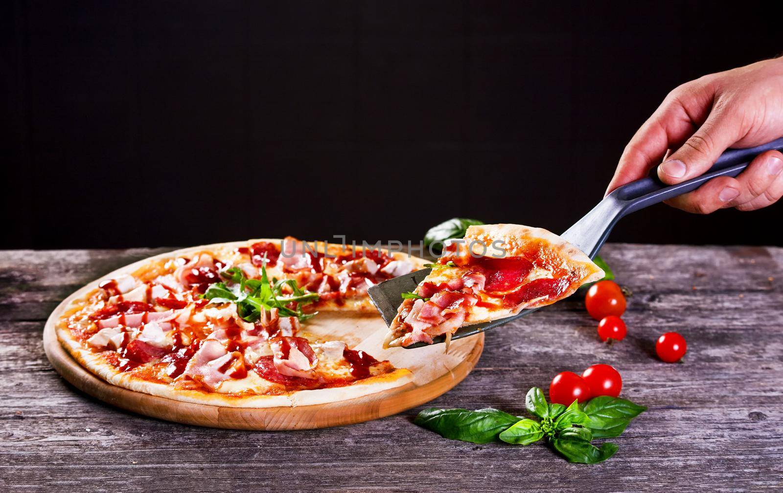 Delicious fresh Pizza with bacon and tomato paste on the wooden background. Top view.