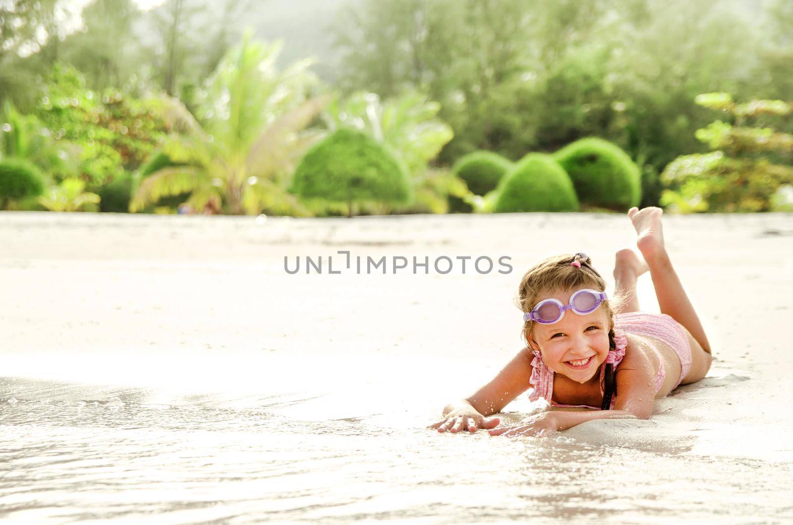 Adorable little girl have fun on the beach