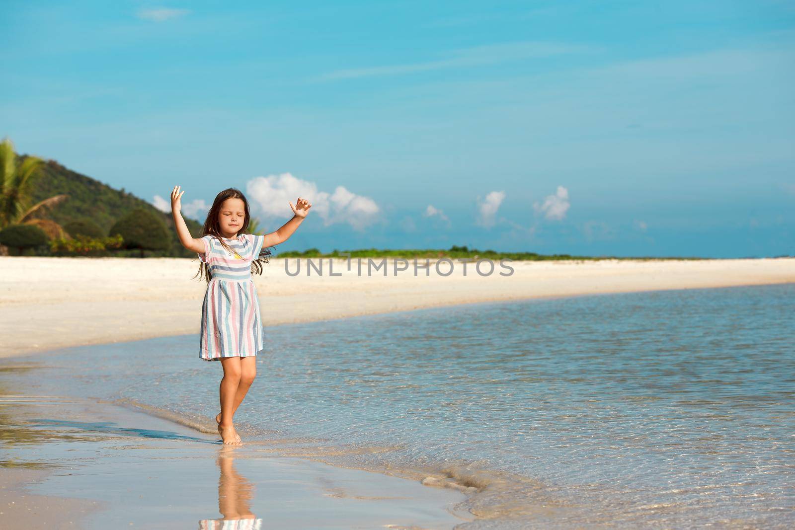 Adorable little girl have fun on the beach