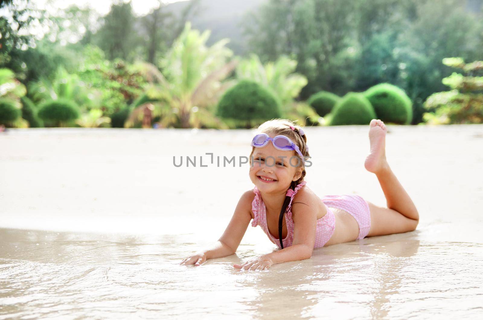 Adorable little girl have fun on the beach