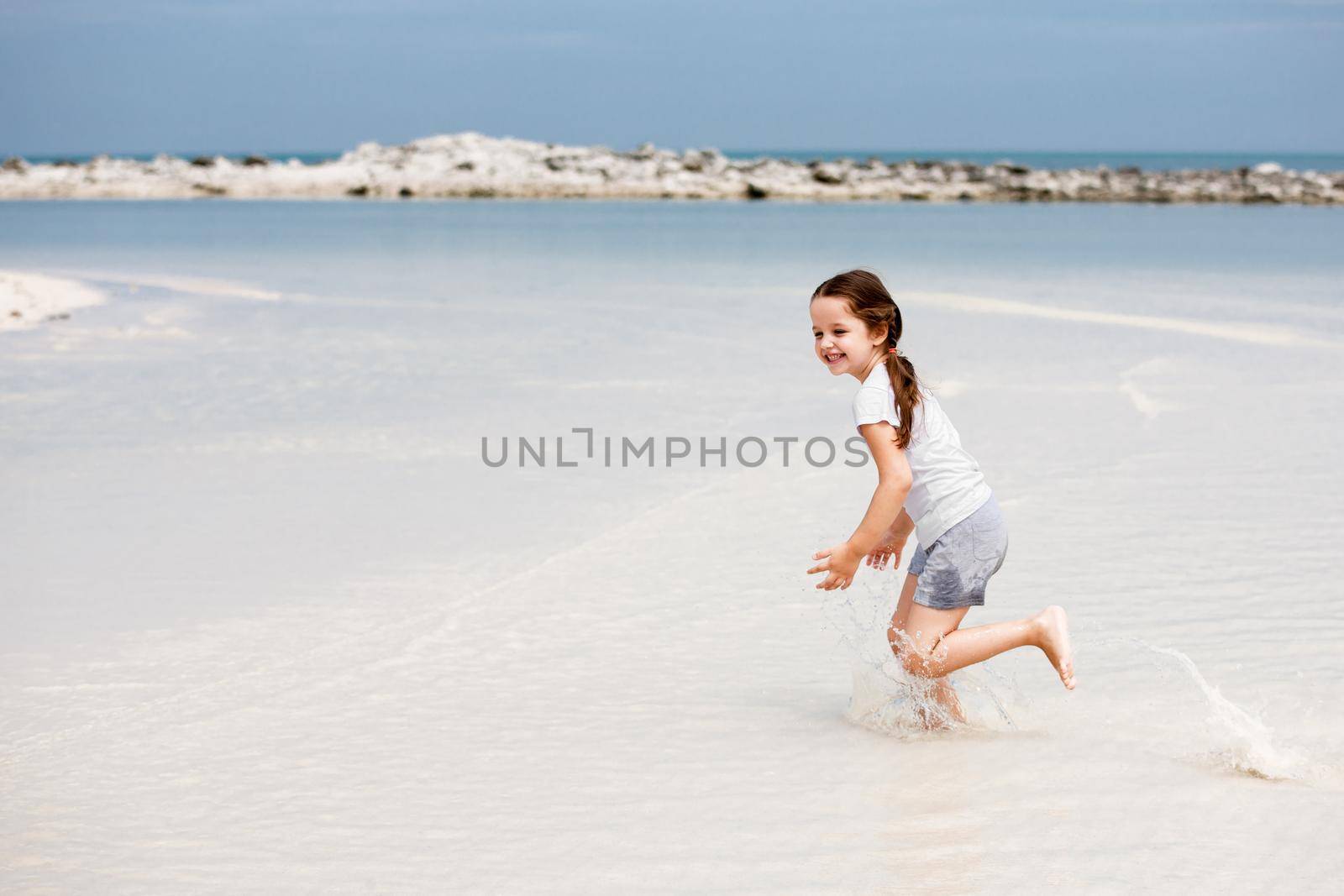 Adorable little girl have fun on the beach