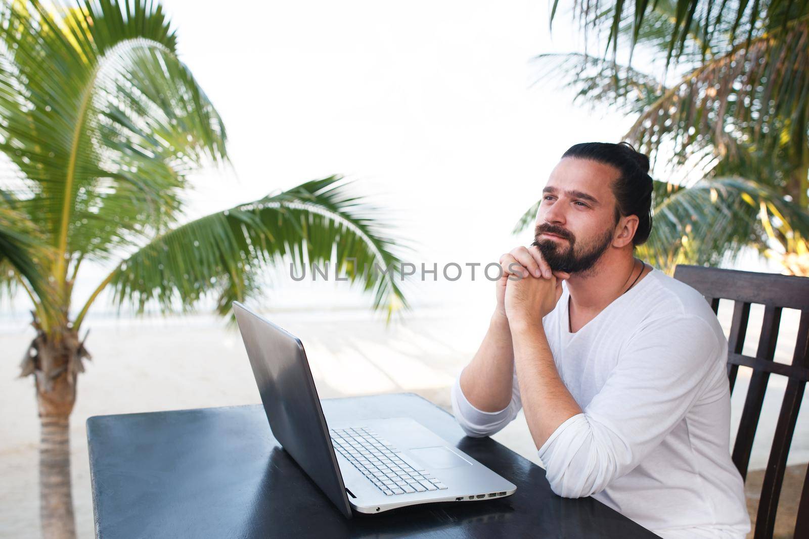 Man relaxing on the beach with laptop, freelancer workplace, dream job by Jyliana