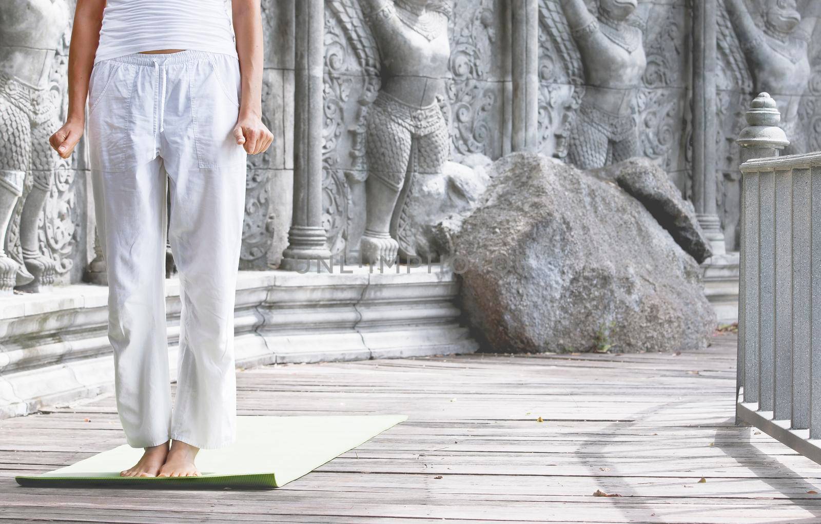 Woman doing yoga in abandoned temple by Jyliana