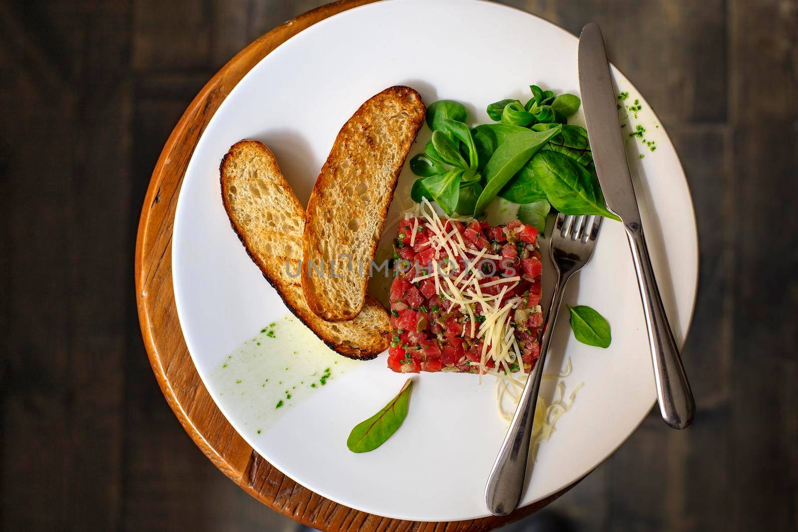 Beef Carpaccio and salad on dark background