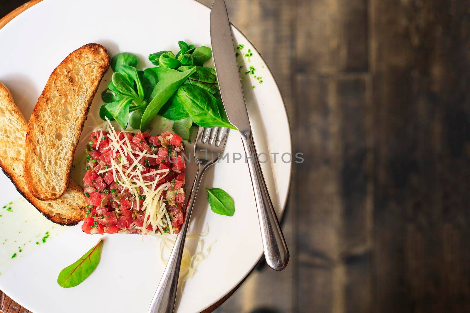 Beef Carpaccio and salad on dark background