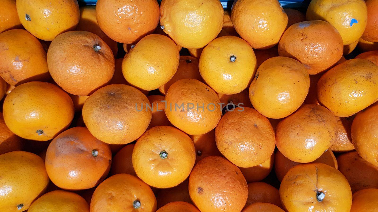 Many oranges are placed in trays for sale to customers. in a shop in Thailand by pichai25