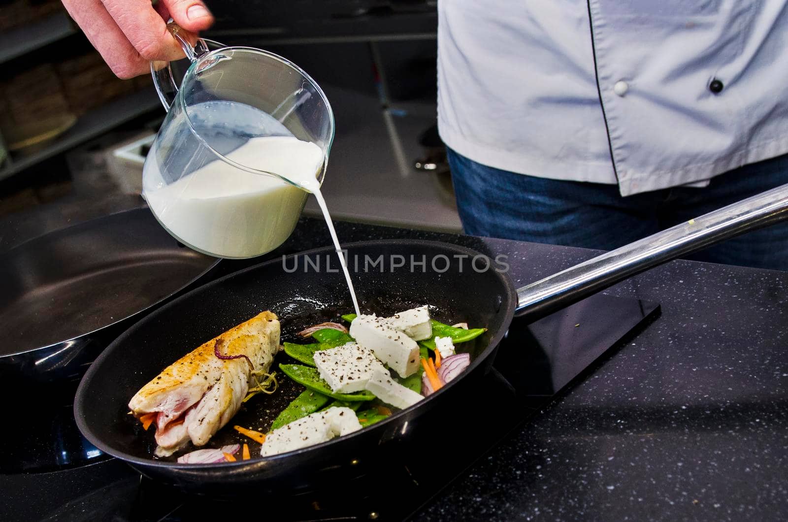 Chef preparing dishes in a frying pan. Cooking. Stock image