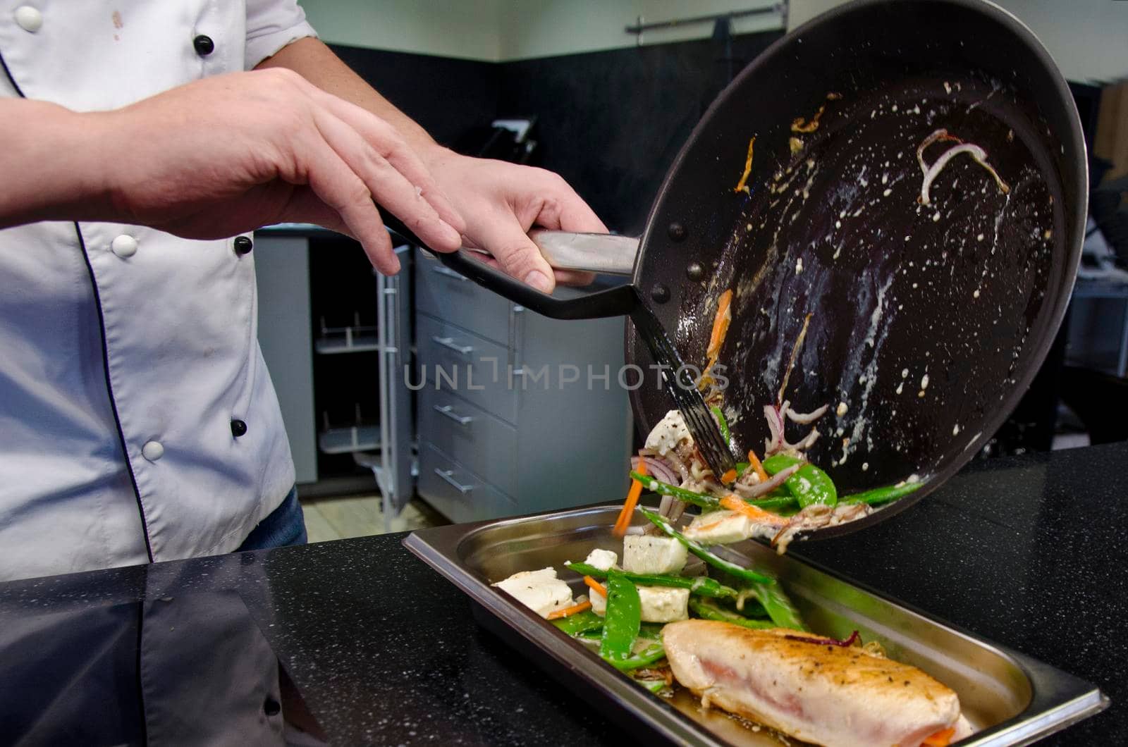 Chef preparing dishes in a frying pan. Cooking. Stock image