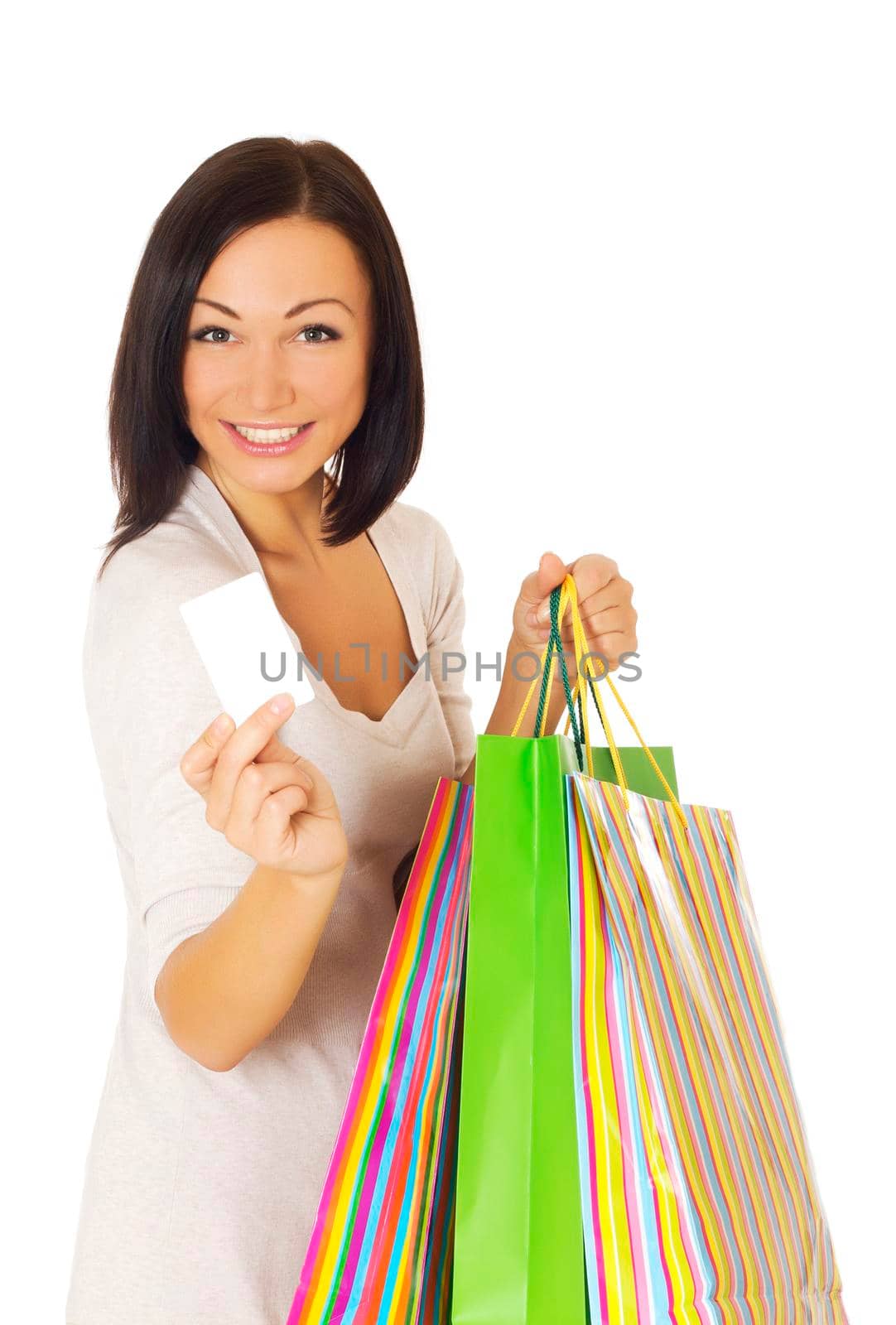 Beautiful woman holding credit card and bags. Isolated on white.