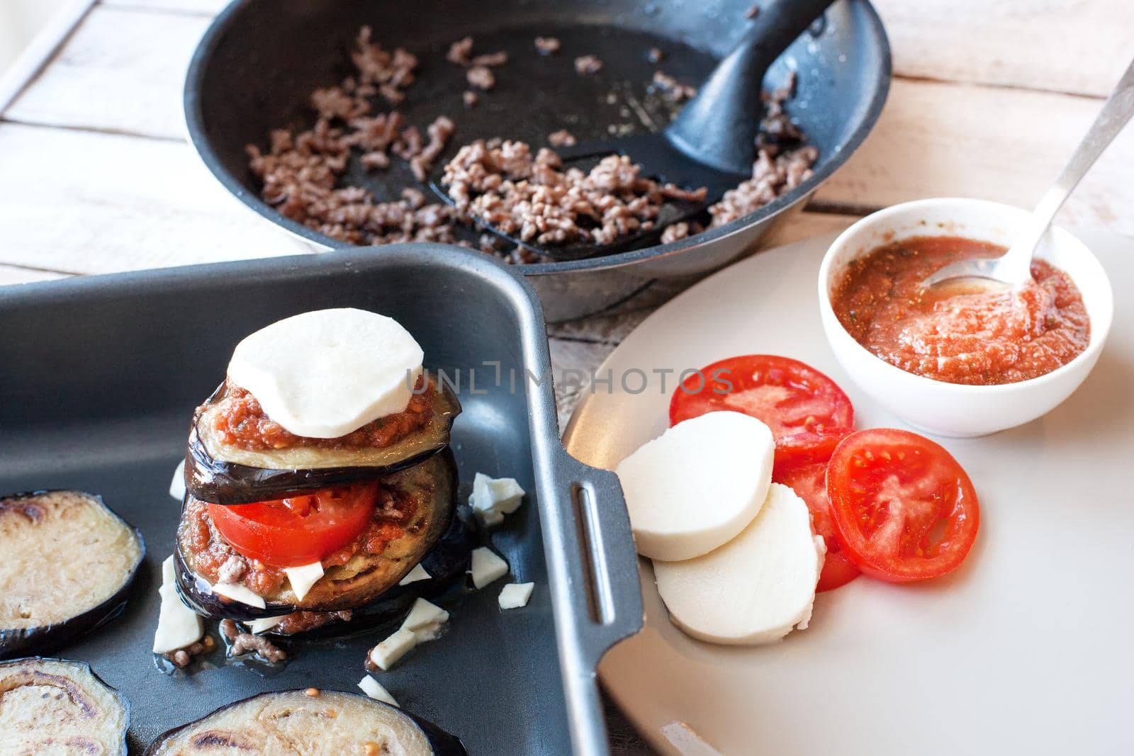 Ingredients for cooking Parmigiana di melanzane: baked eggplant - italy, sicily cousine. On the wooden table.