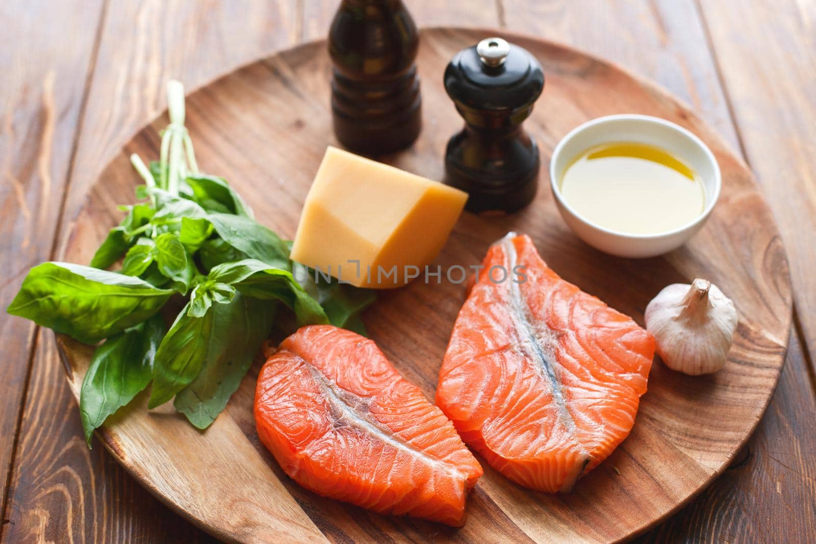 Raw humpback salmon steaks, cheese, rustic wooden background, above view. Fillet with fresh ingredients for tasty cooking and frying pan. Top view. Healthy and diet food concept.