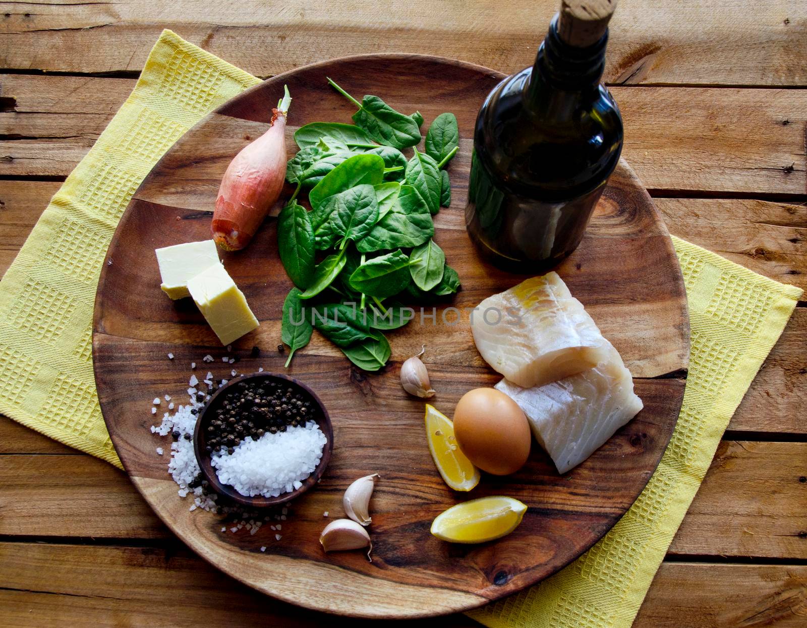 Poached mackerel fish, spinach and egg salad on a dark background, top view. Delicious healthy food concept