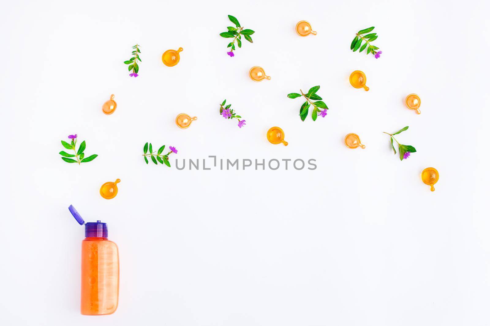 Bottle of essential oil with fresh meadow herbs and flowers on white background. Flat lay, top view, natural