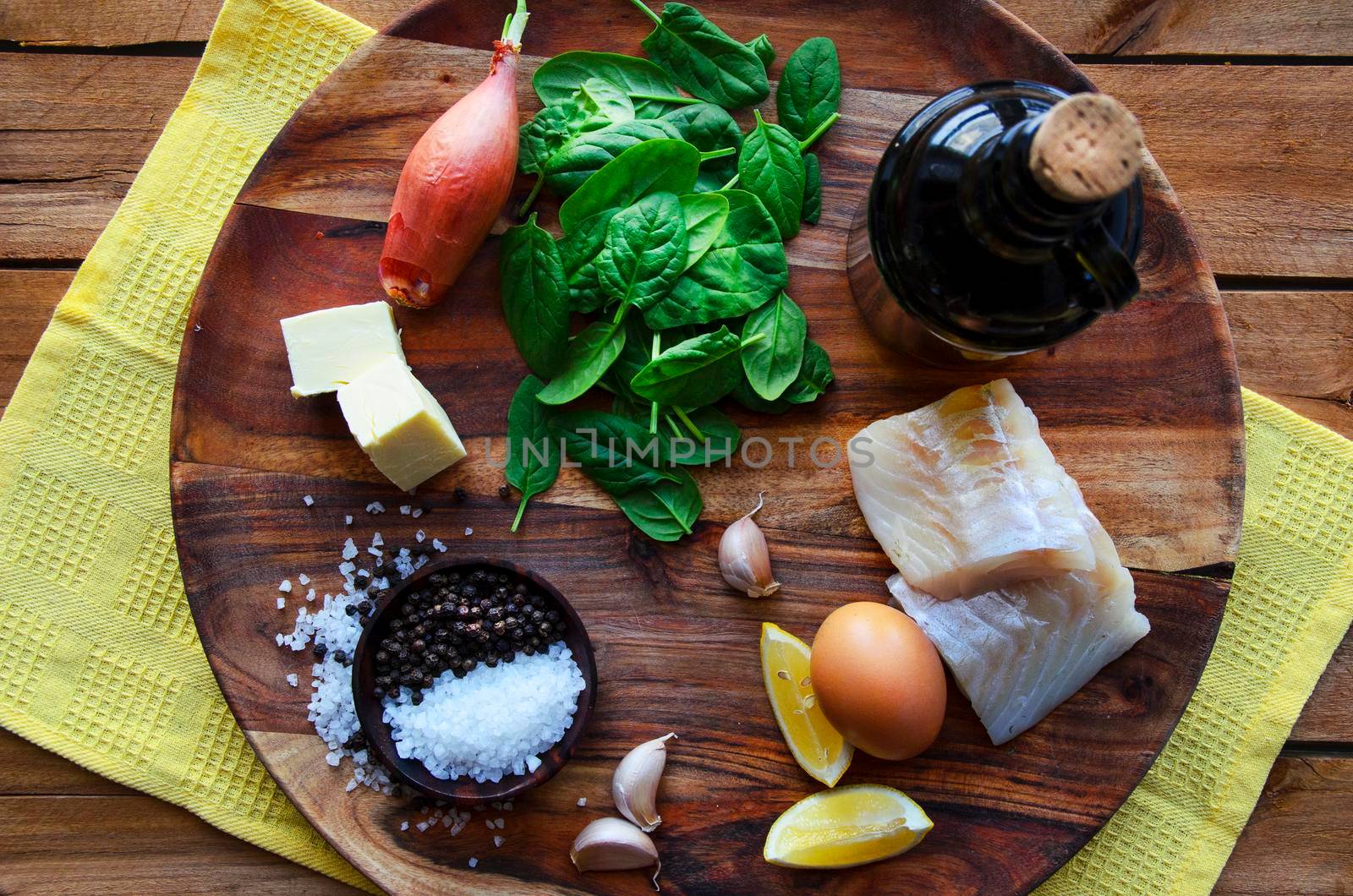 Poached mackerel fish, spinach and egg salad on a dark background, top view. Delicious healthy food concept