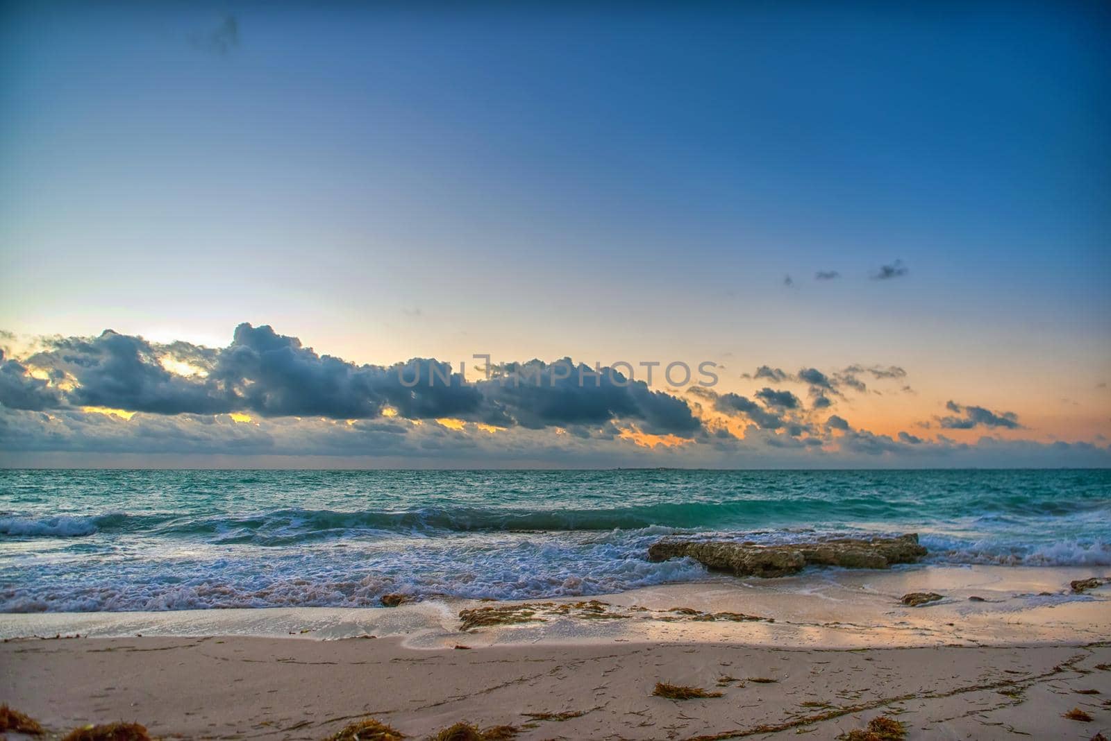 Sunset on the Caribbean Sea. Clear sky with small clouds. Clear weather.