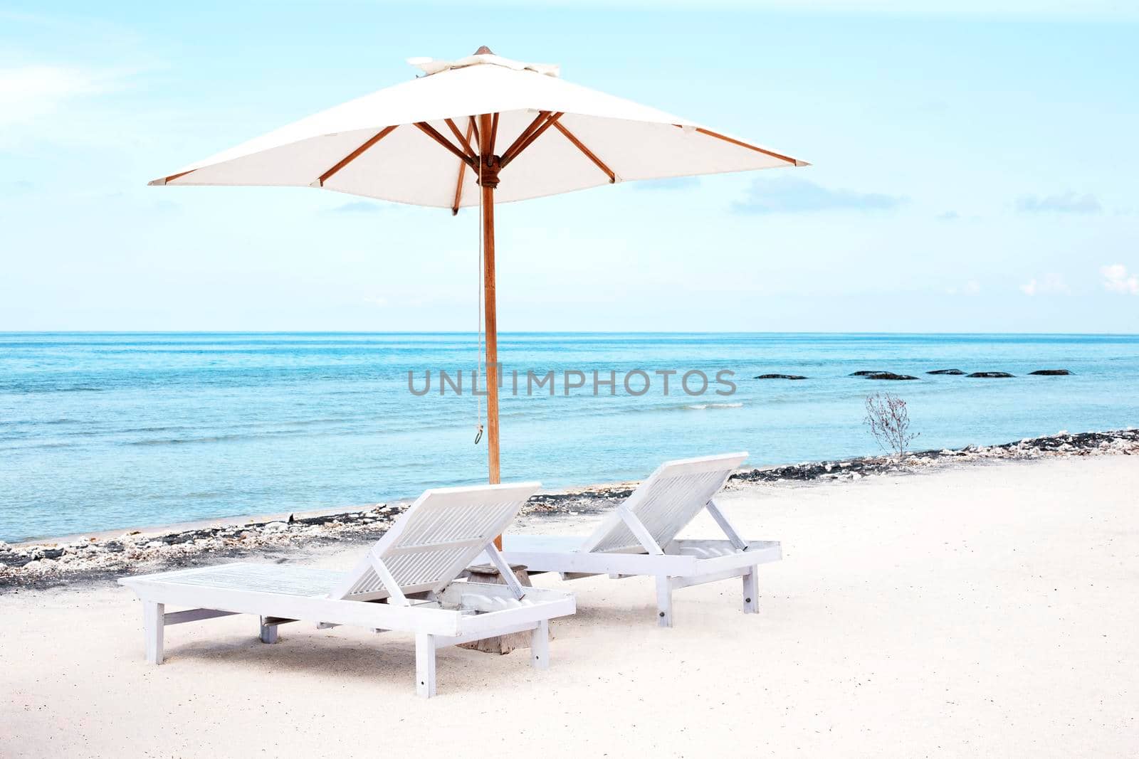 Beach chairs and Parasol on exotic tropical white sandy by Jyliana