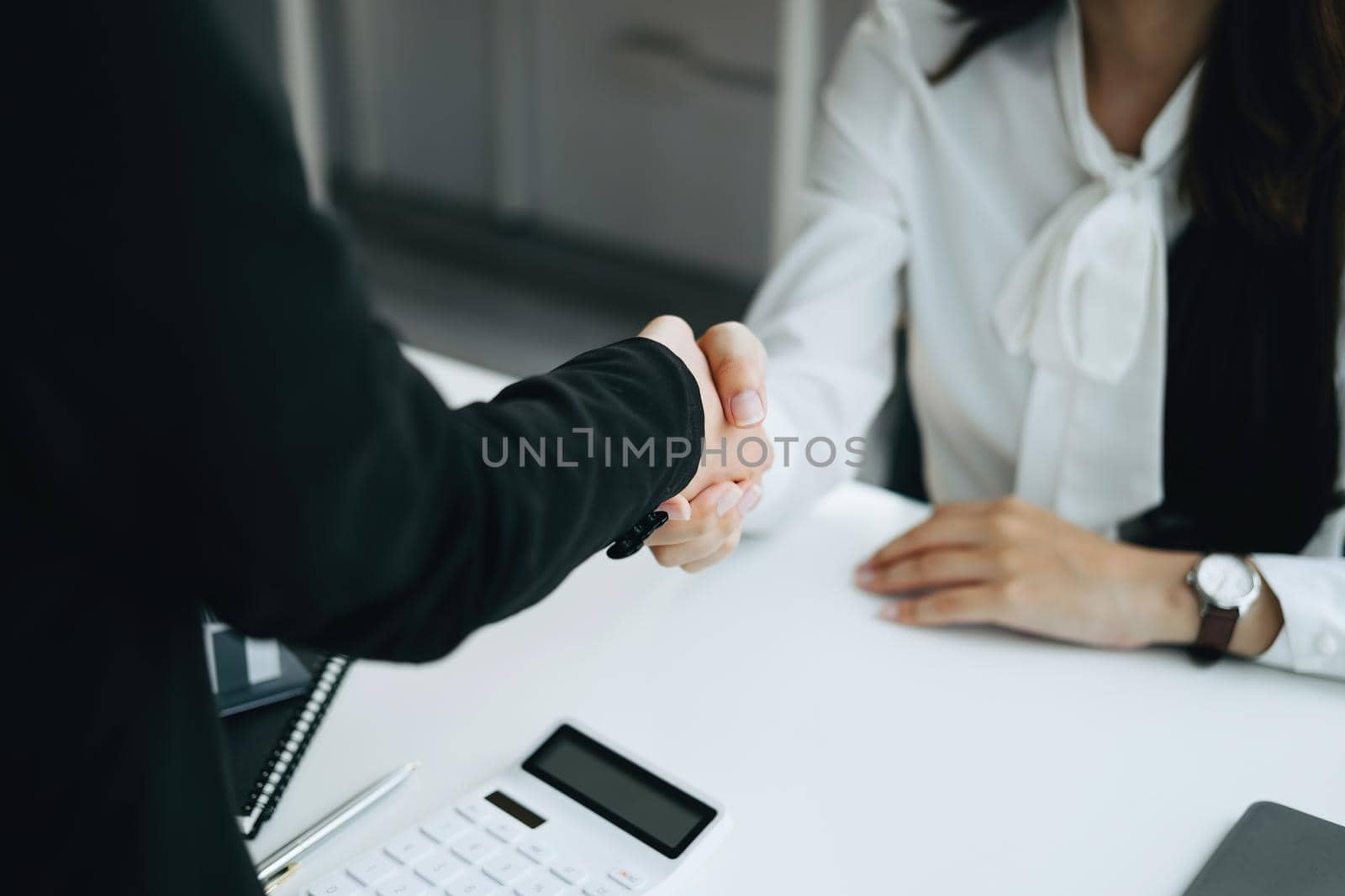 Guarantees, Mortgages, Signings, Insurance, contract, agreement concept, Real Estate Agents are shaking hands with customers to congratulate them after landing a deal by Manastrong