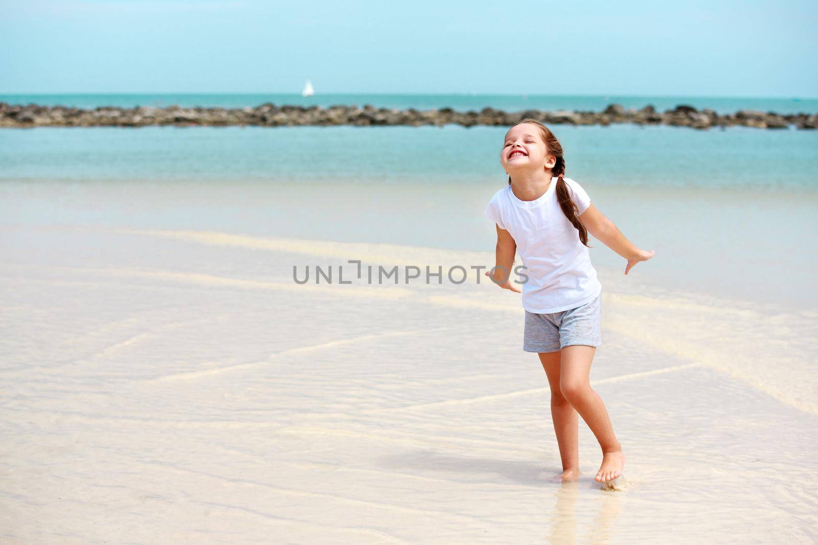 Adorable little girl have fun on the beach