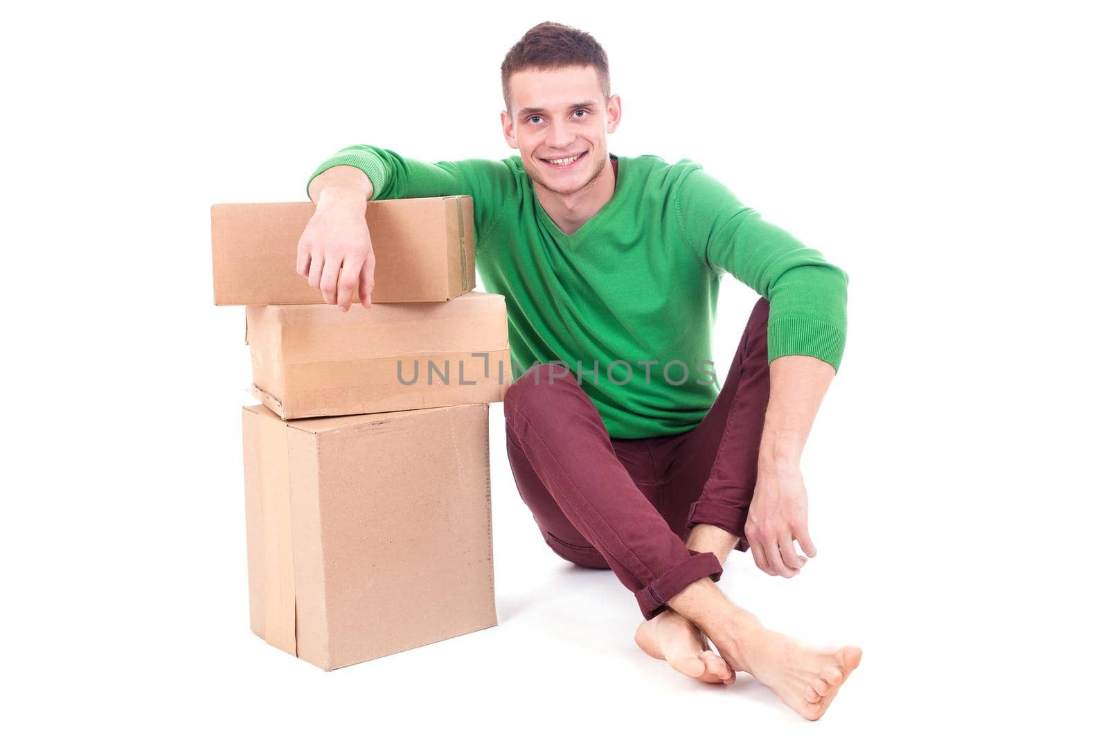Sad, tired and surprised deliveryman hardly carries the parcel, isolated, white background