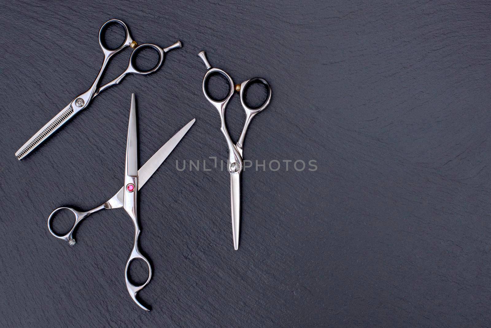 Hairdresser Accessories, Razor for cutting hair with copy space on gray background. set of scissors