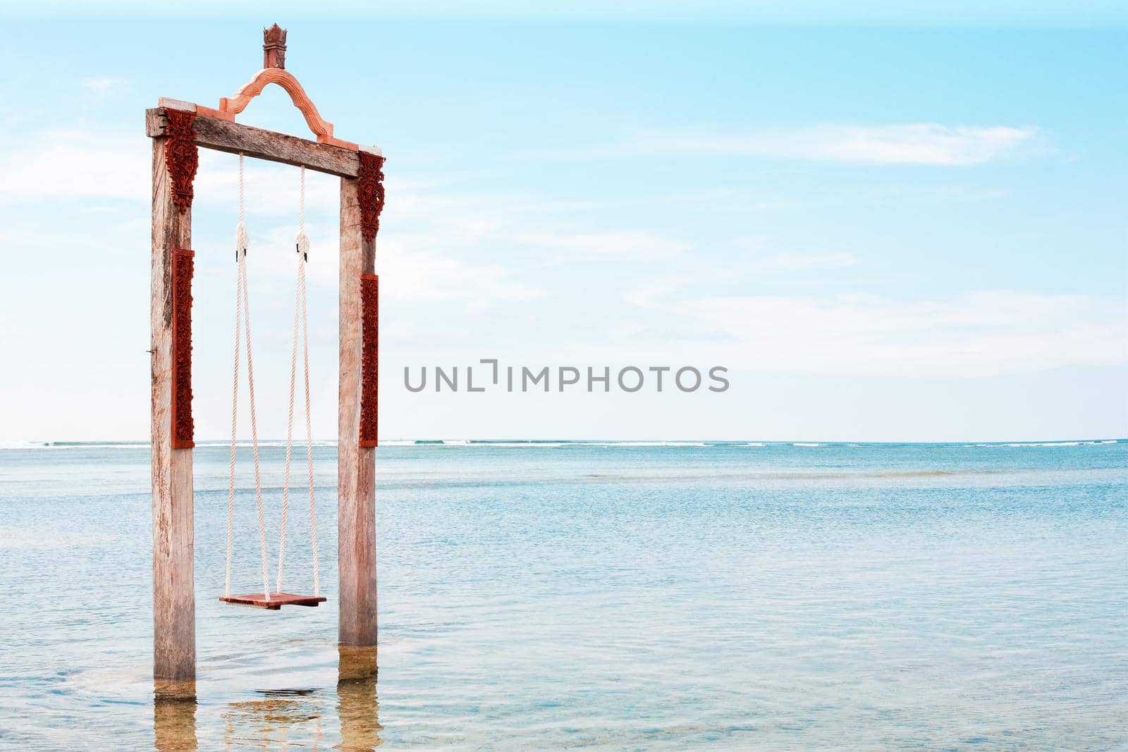 Swing above the sea. Iconic tourist attraction in Gili Trawangan island in Lombok, Indonesia.