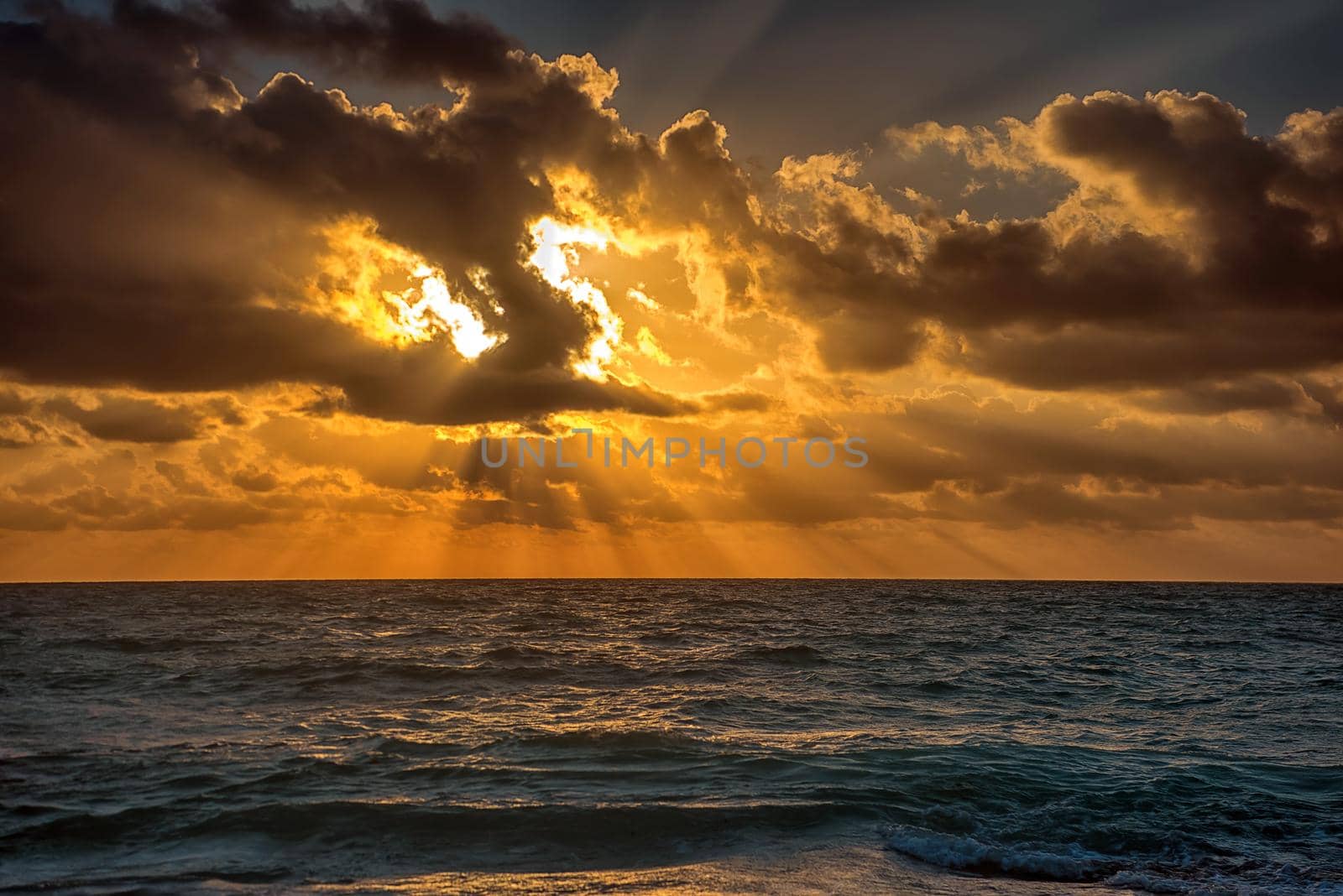 Sunset on the Caribbean Sea. Clear sky with small clouds. Clear weather.