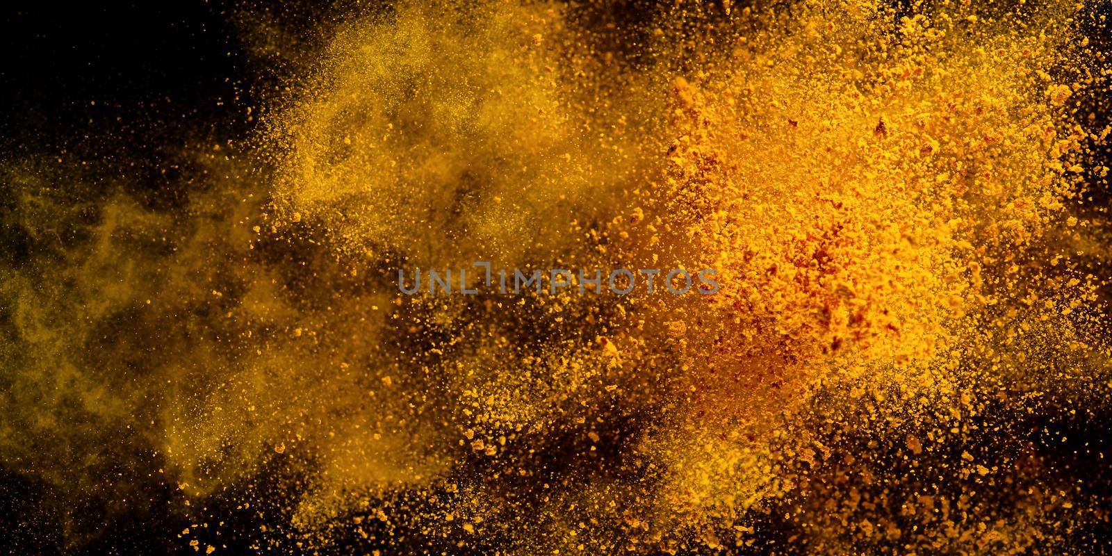 Explosion, Splashes of turmeric on a black background. India Seasoning. The orange powder of the turmeric root. by PhotoTime