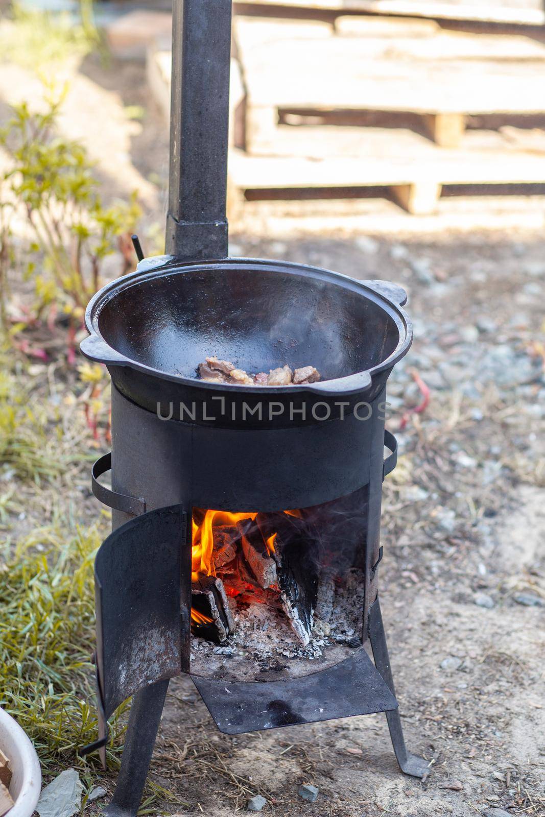 Cooking in cauldron on open fire in nature. by AnatoliiFoto