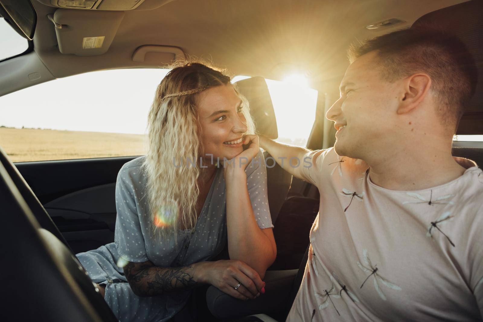 Happy Couple Enjoying Road Trip, Young Caucasian Woman and Man Having Fun Time While Traveling by Car by Romvy