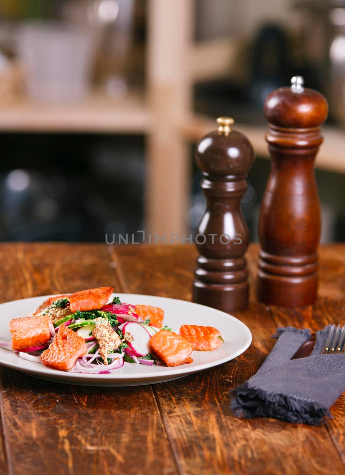 Grilled salmon with radish and spinach, served on white plate. View from above, top studio shot by Jyliana