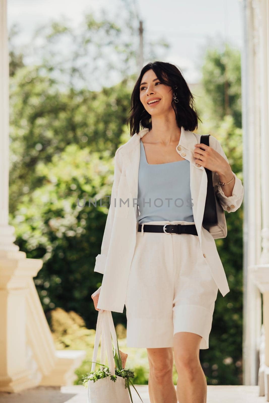 Vertical Portrait of Cheerful Brunette Woman Holding Shopping Eco Bag Outdoors at Sunny Summer Day