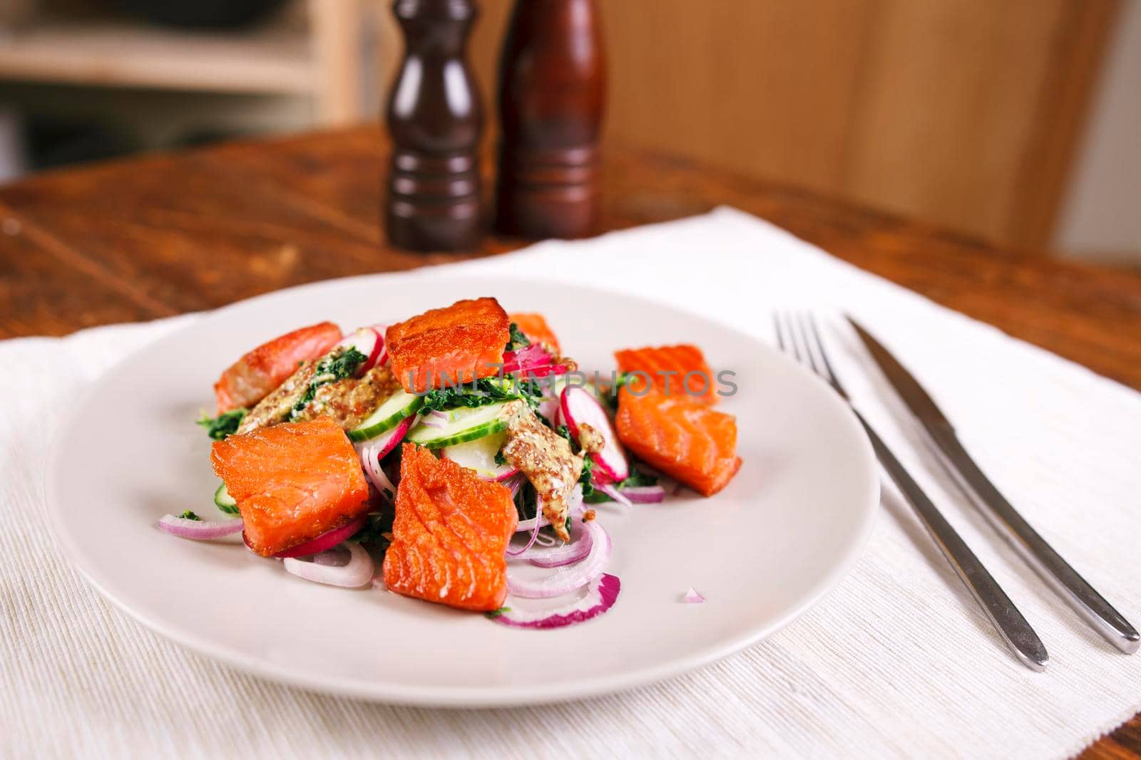 Grilled salmon with radish and spinach, served on white plate. View from above, top studio shot by Jyliana