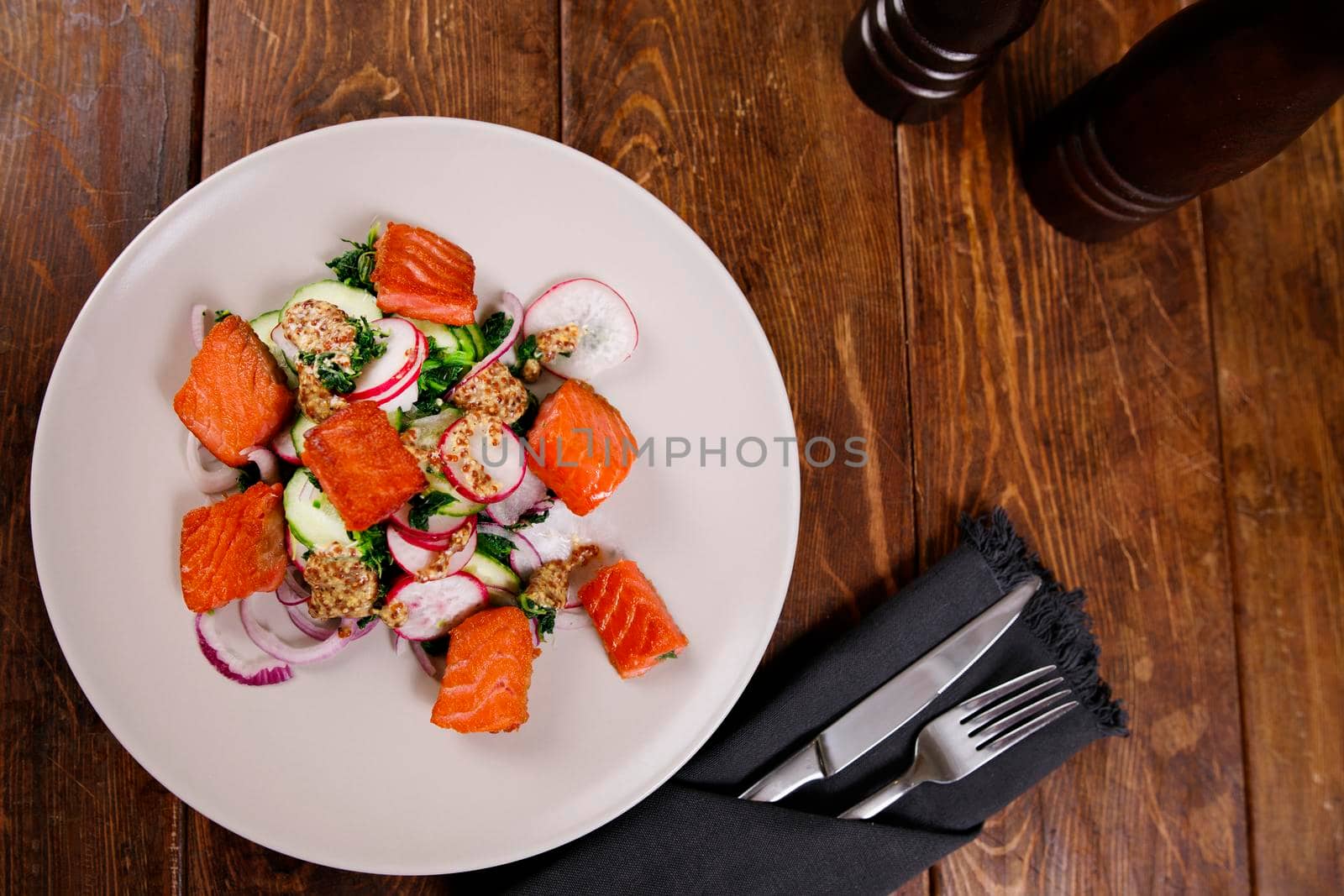 Grilled salmon with radish and spinach, served on white plate. View from above, top studio shot by Jyliana