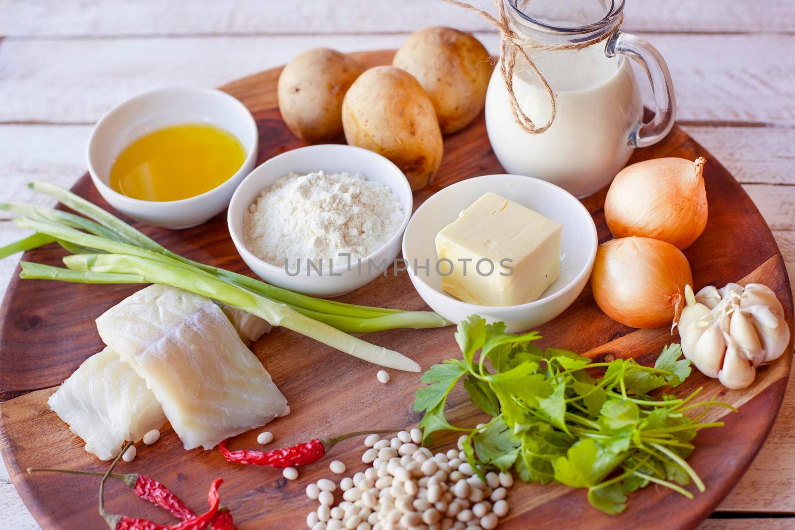 healthy eating and diet concept - natural food on table. Ingredients Fish Beans Parsley Onion Cream Potatoes for meatballs