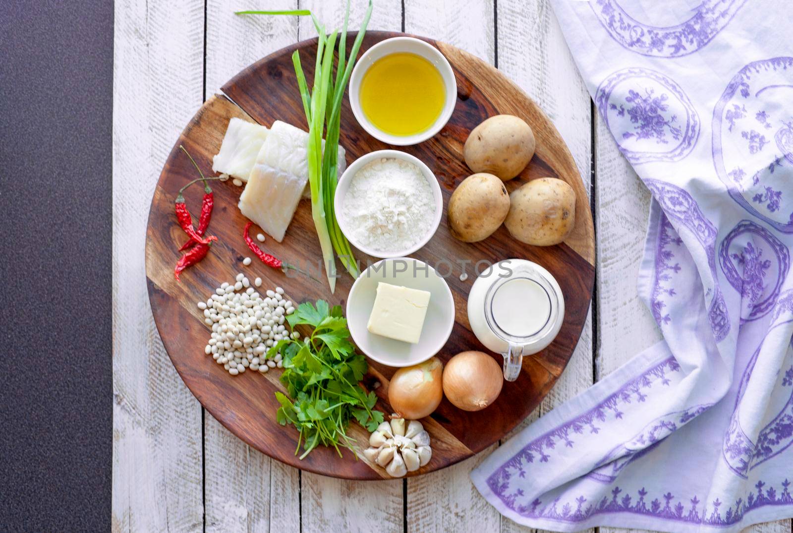 healthy eating and diet concept - natural food on table. Ingredients Fish Beans Parsley Onion Cream Potatoes for meatballs