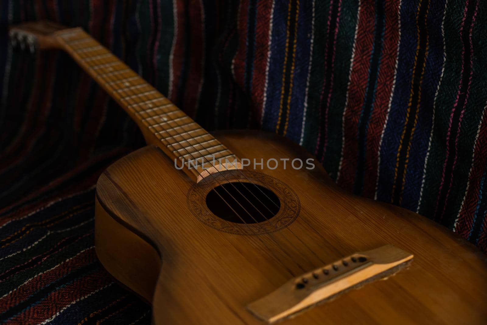 spanish guitar on a old chair with wooden background horizontal by Andelov13