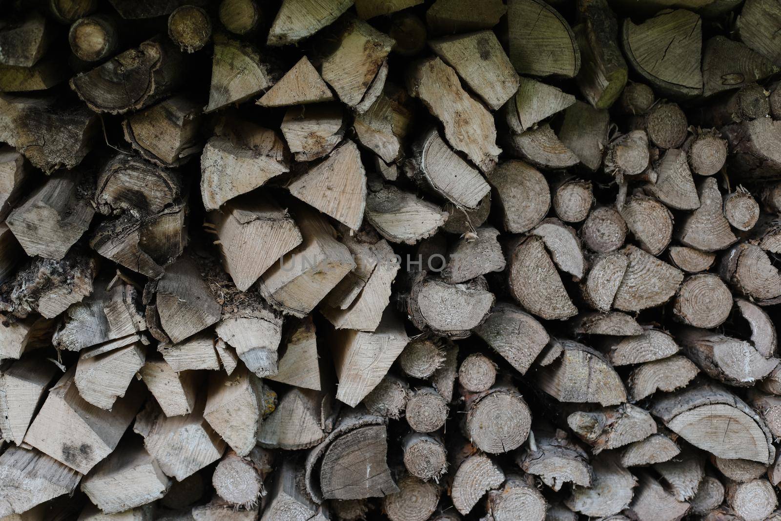 pile stacked natural sawn wooden logs background. Background of birch logs, stacked on top of each other. Wall of stacked wood logs as background
