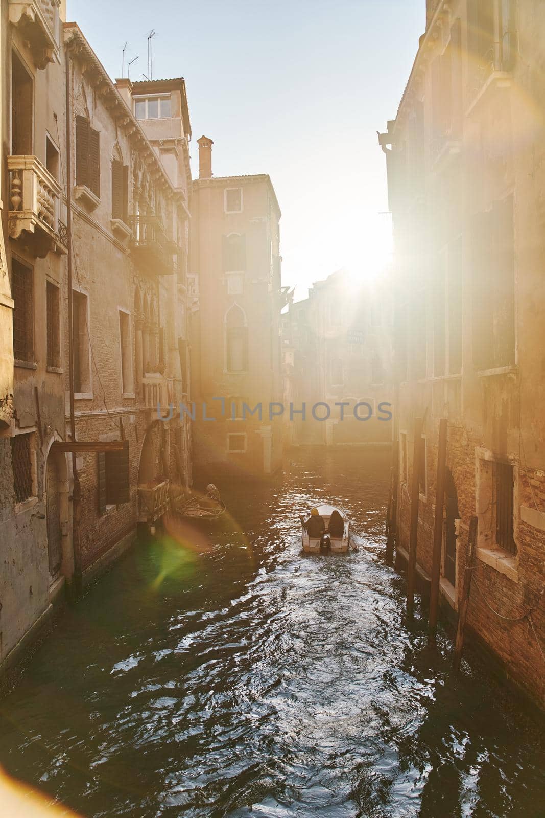 Venice, Italy - 10.12.2021: Traditional canal street with gondolas and boats in Venice, Italy. High quality photo