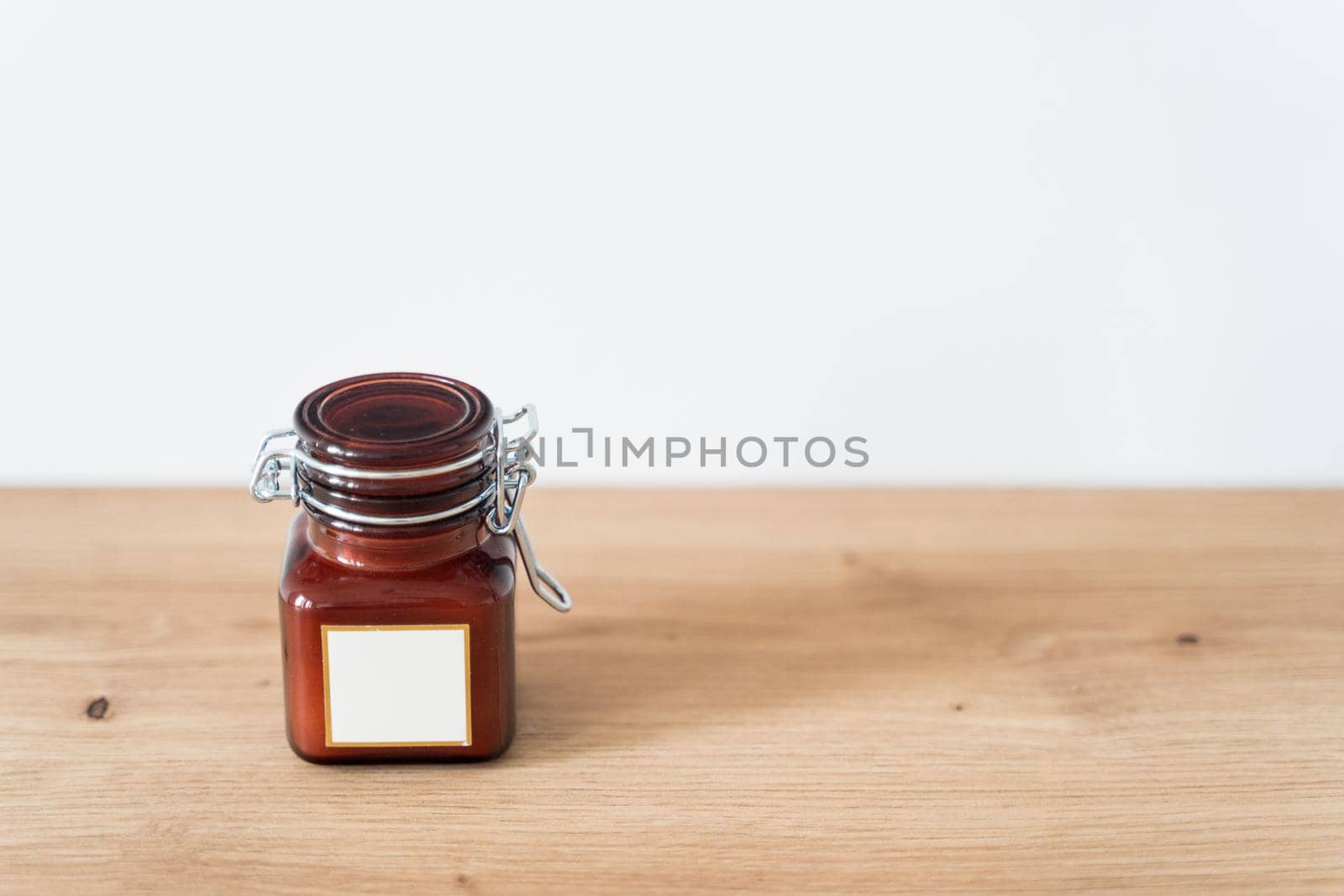 Scented candle in a glass jar on a white background. Glass jar with aromatic candle. High quality photo