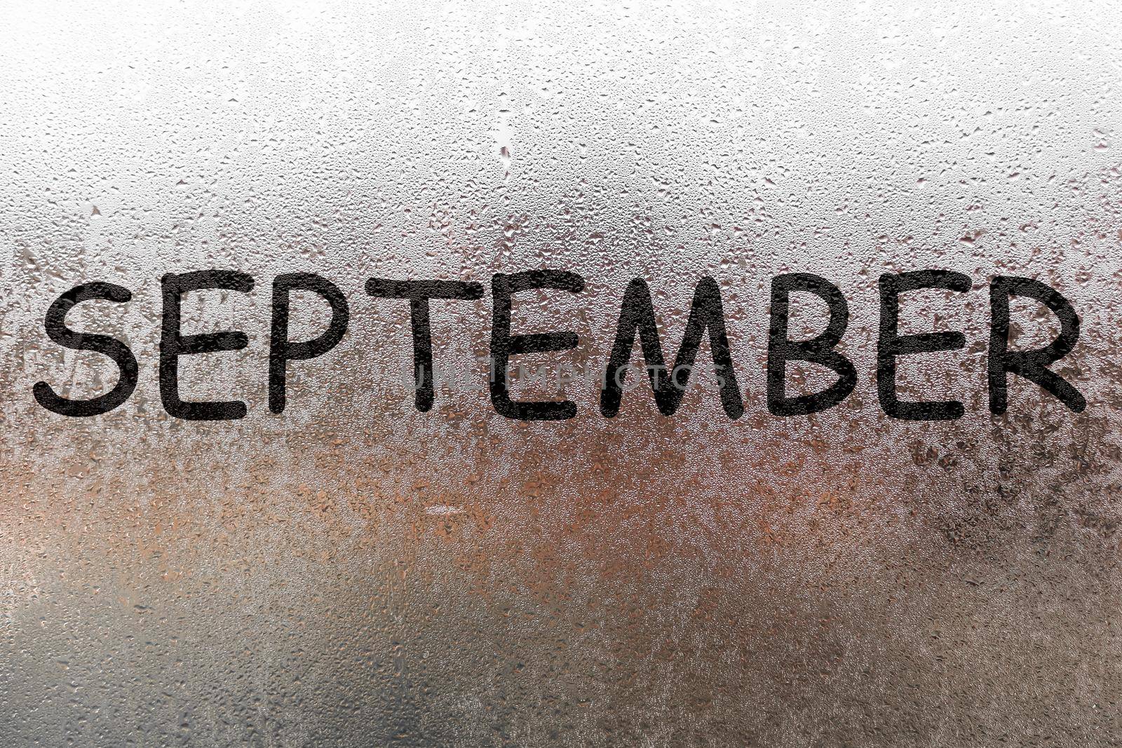 Autumn rain, the inscription on the sweaty glass - September.