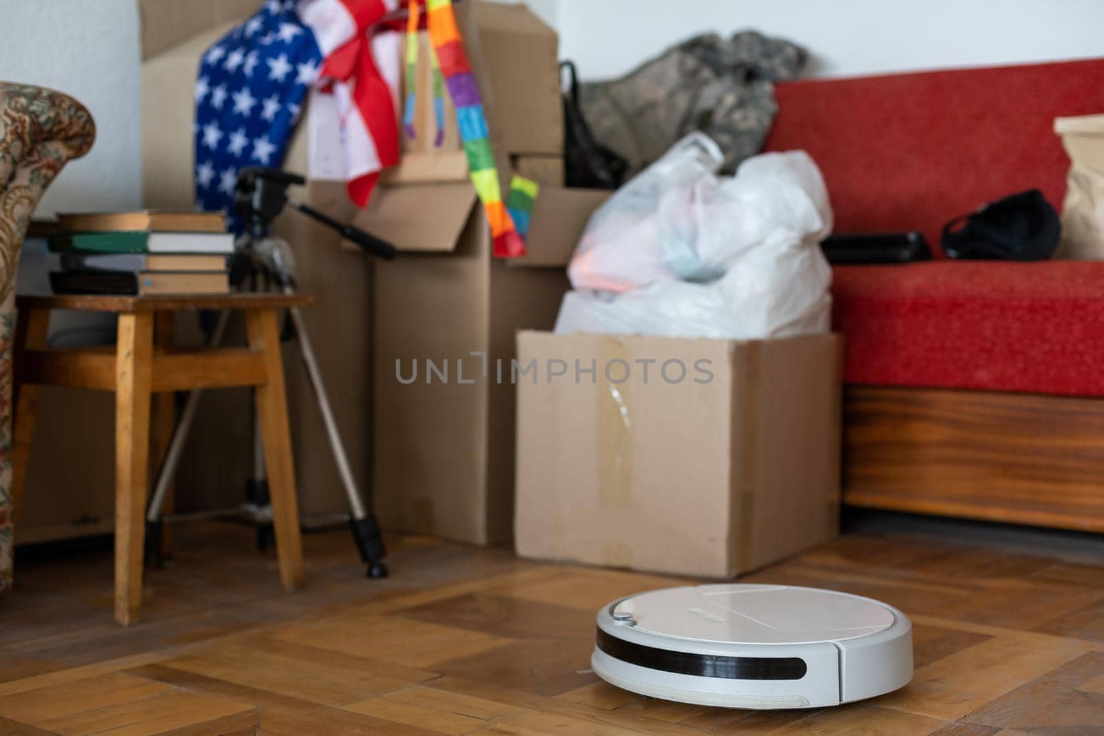 boxes with things to move and robot vacuum cleaner