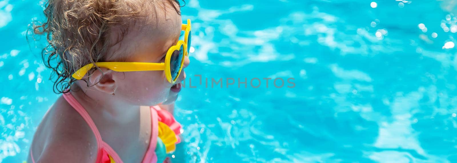 Baby swims in the pool. Selective focus. Child.