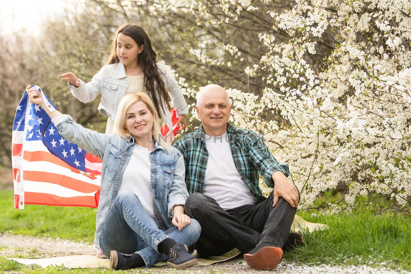 american family with USA flag outdoors