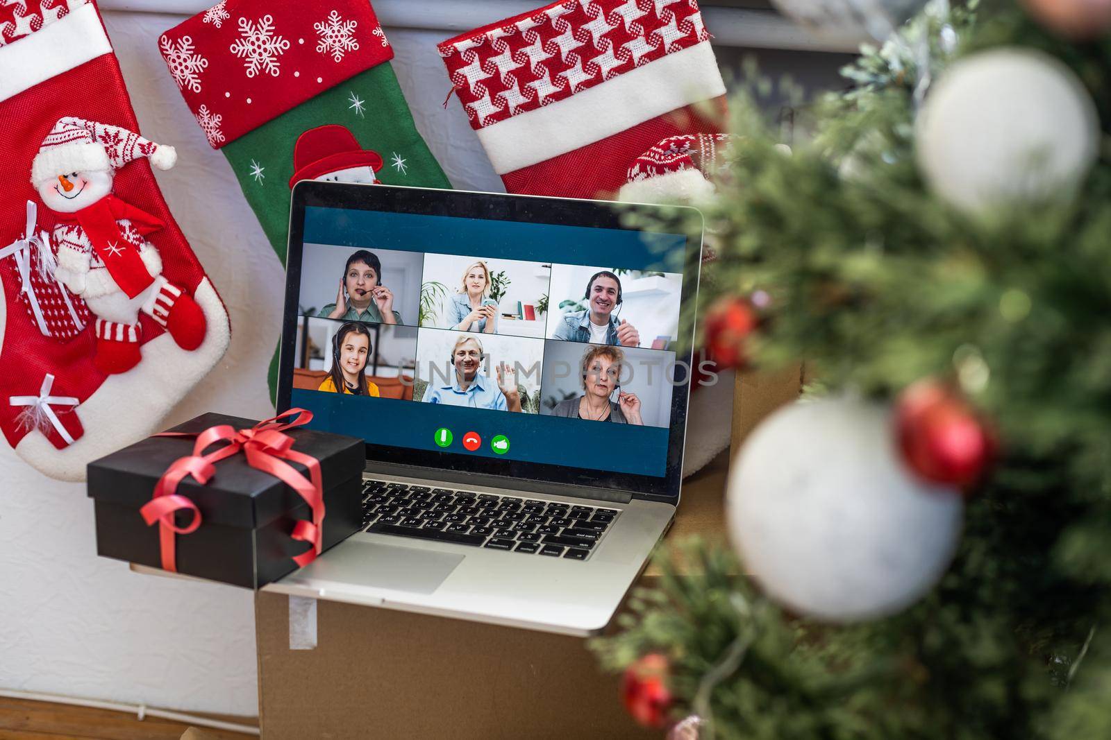 Virtual Christmas day house party. video conferencing, video call via computer in the home office. Online team gift opening conference calling