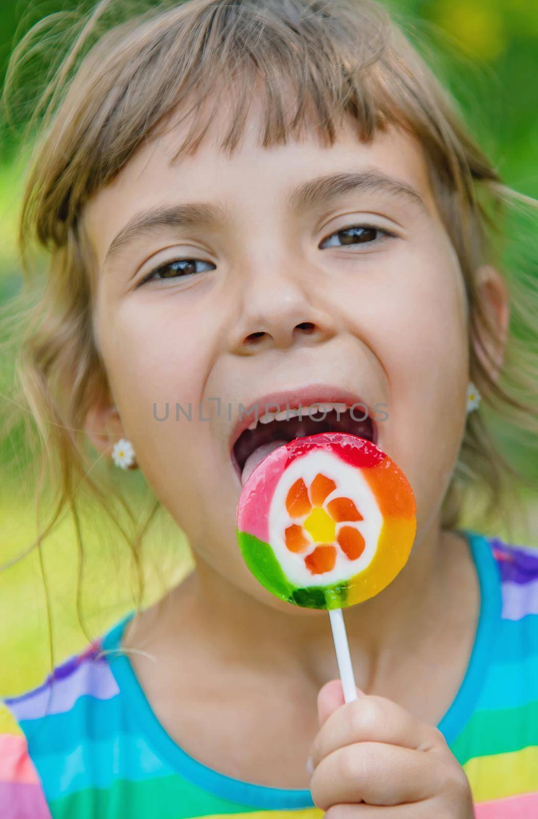 Lollipops in the hands of child. Selective focus.
