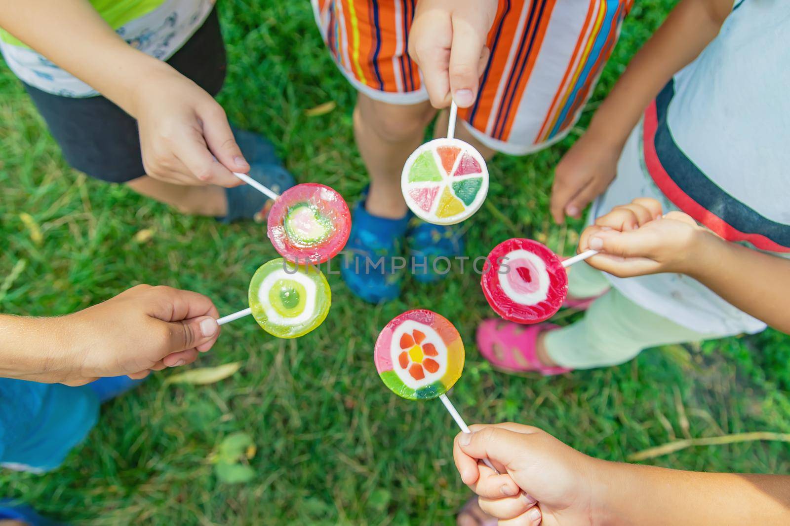 Lollipops in the hands of children. Selective focus. by yanadjana