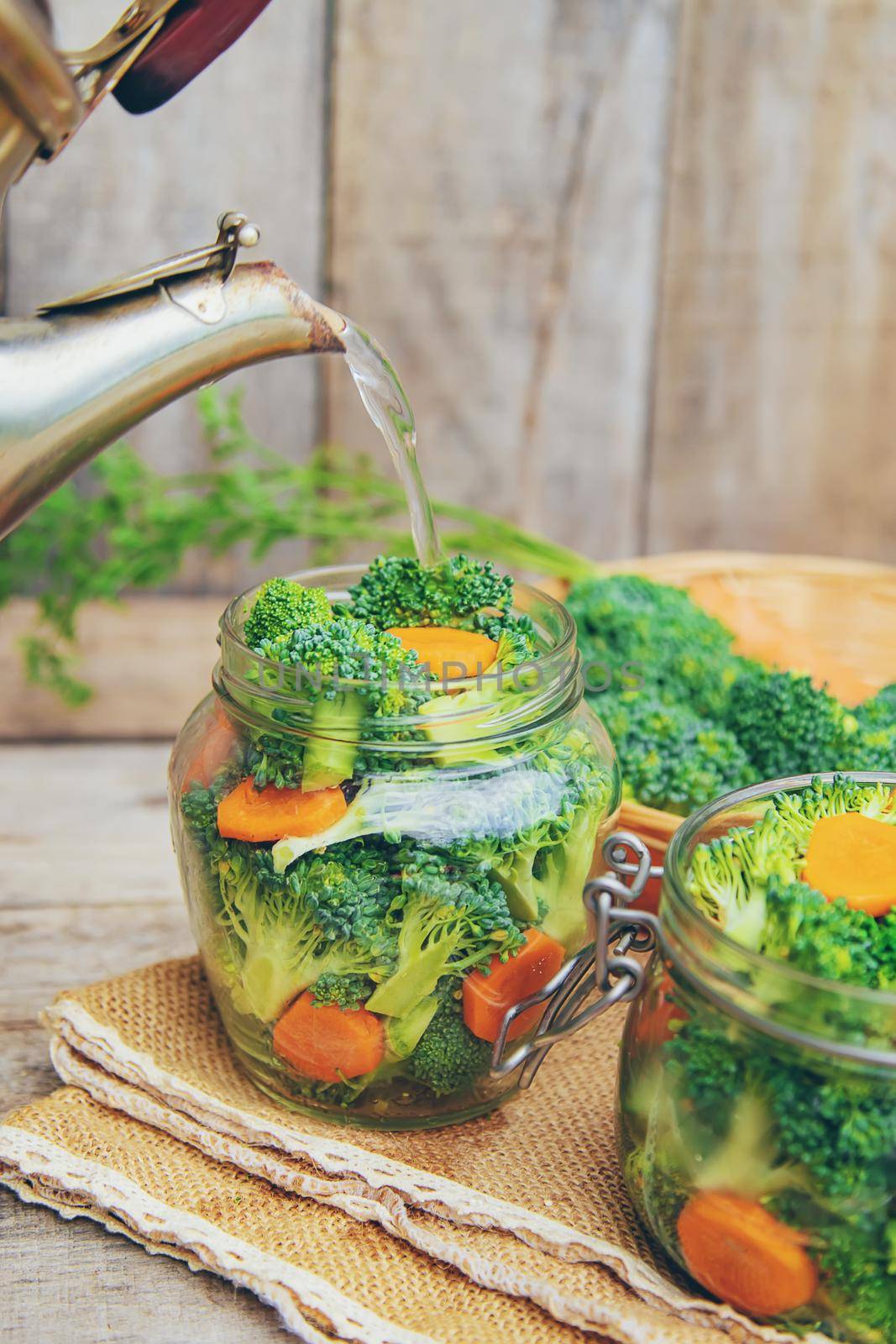 Preservation of broccoli with carrots in jars. Selective focus. nature.