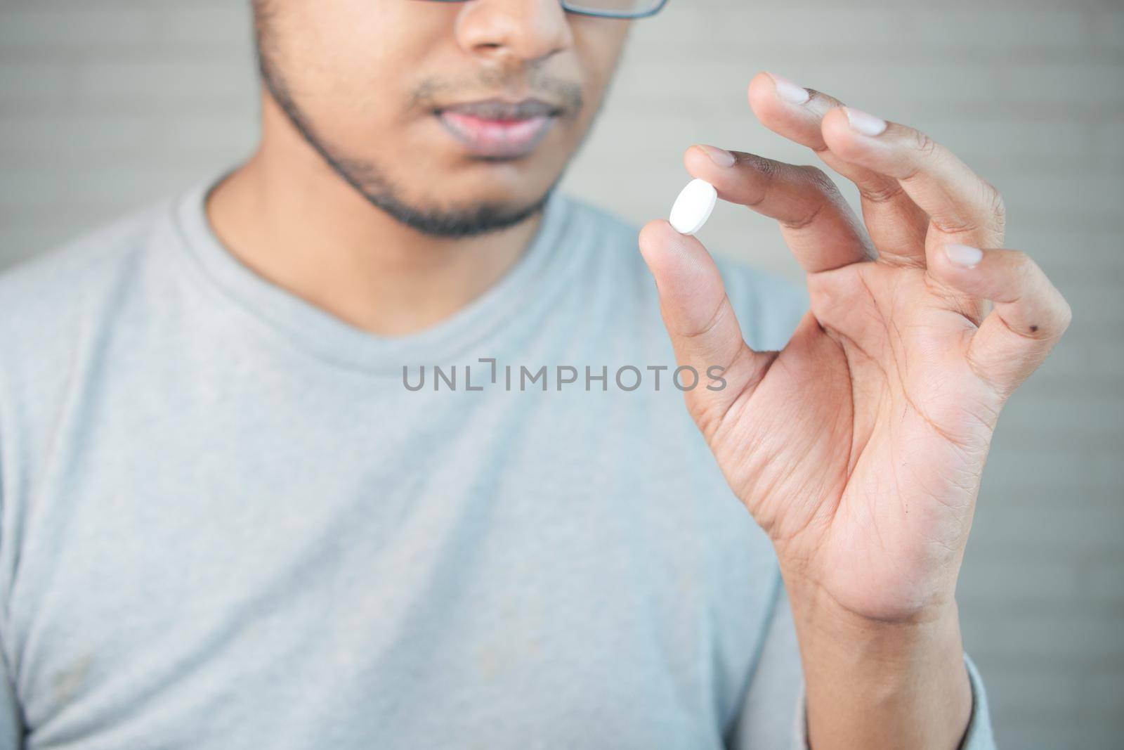 upset man hand holding medical pills .